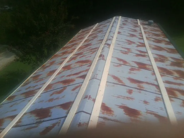 Rusted metal roof panels with new wood purlins before replacement — Storm Damage Roof Repair in Lengby by Roofing Brothers